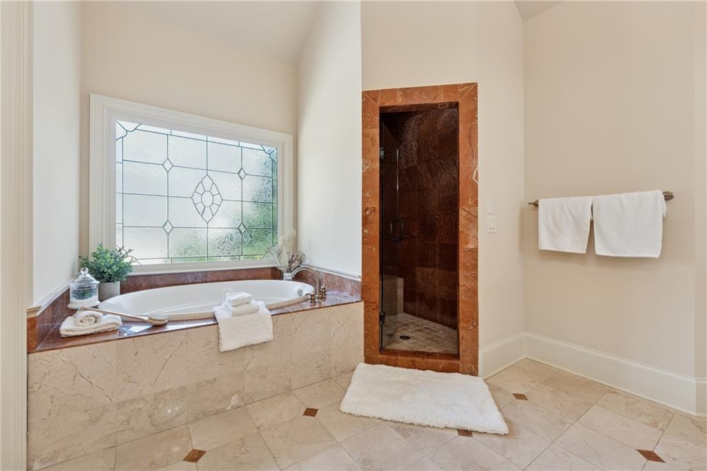 6935 Wakehurst Place Cumming, GA 30040 - Photo 46 of 92 a bath room with a bath tub and a shower