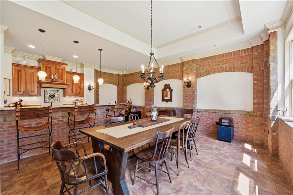 6935 Wakehurst Place Cumming, GA 30040 - Photo 65 of 92 a large kitchen with a table and chairs