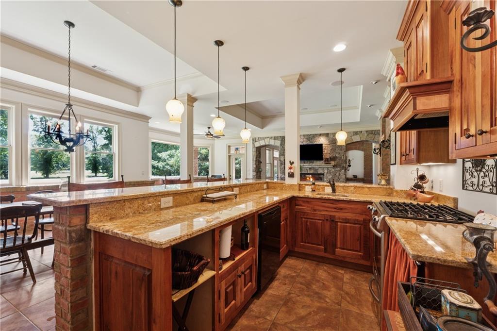6935 Wakehurst Place Cumming, GA 30040 - Photo 69 of 92 a kitchen with stainless steel appliances granite countertop a stove a sink and a wooden floors