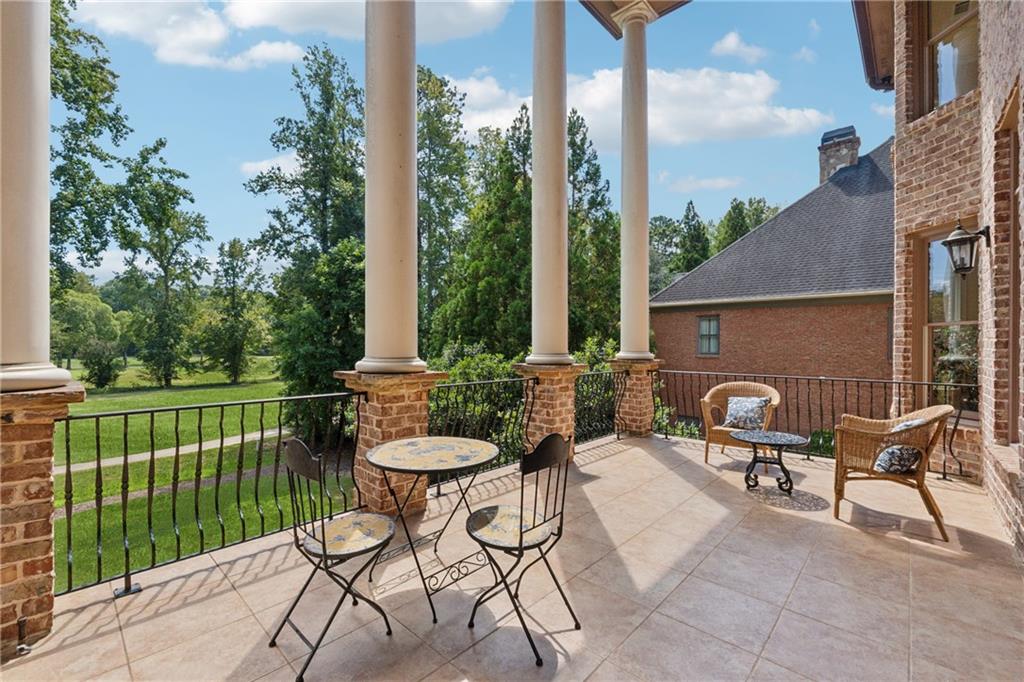 6935 Wakehurst Place Cumming, GA 30040 - Photo 73 of 92 a view of a chairs and table in patio with a small yard