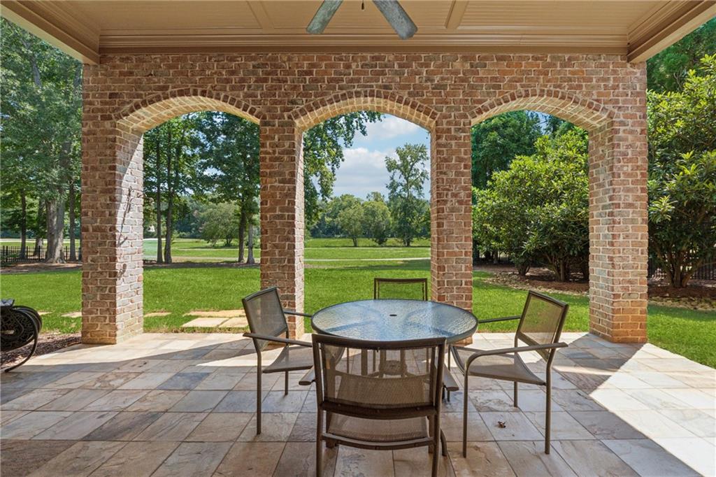 6935 Wakehurst Place Cumming, GA 30040 - Photo 74 of 92 a view of a patio with a table chairs and a backyard