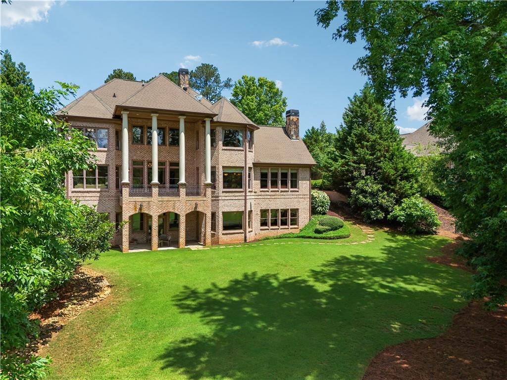 6935 Wakehurst Place Cumming, GA 30040 - Photo 76 of 92 a view of a house with a yard and sitting area