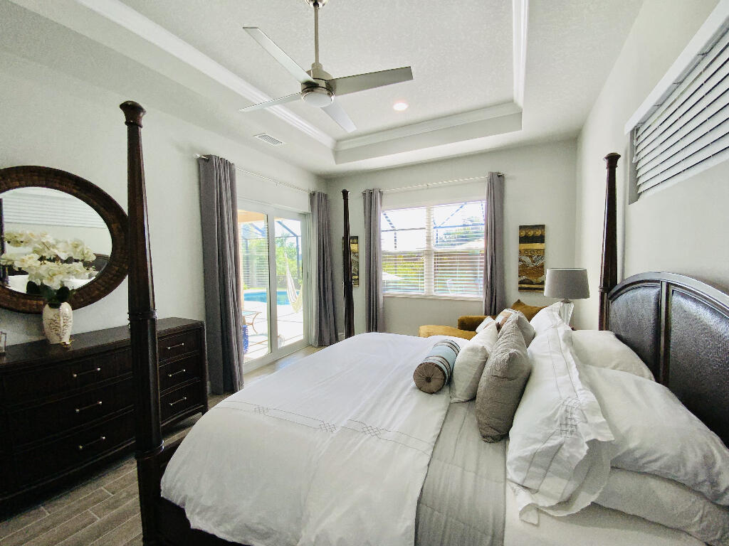 4644 Capri Lane Melbourne, FL 32935 - Photo 19 of 43 a bedroom with a bed and a dresser