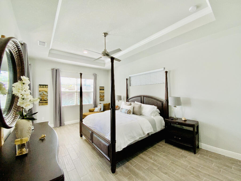 4644 Capri Lane Melbourne, FL 32935 - Photo 20 of 43 a bedroom with a bed and window