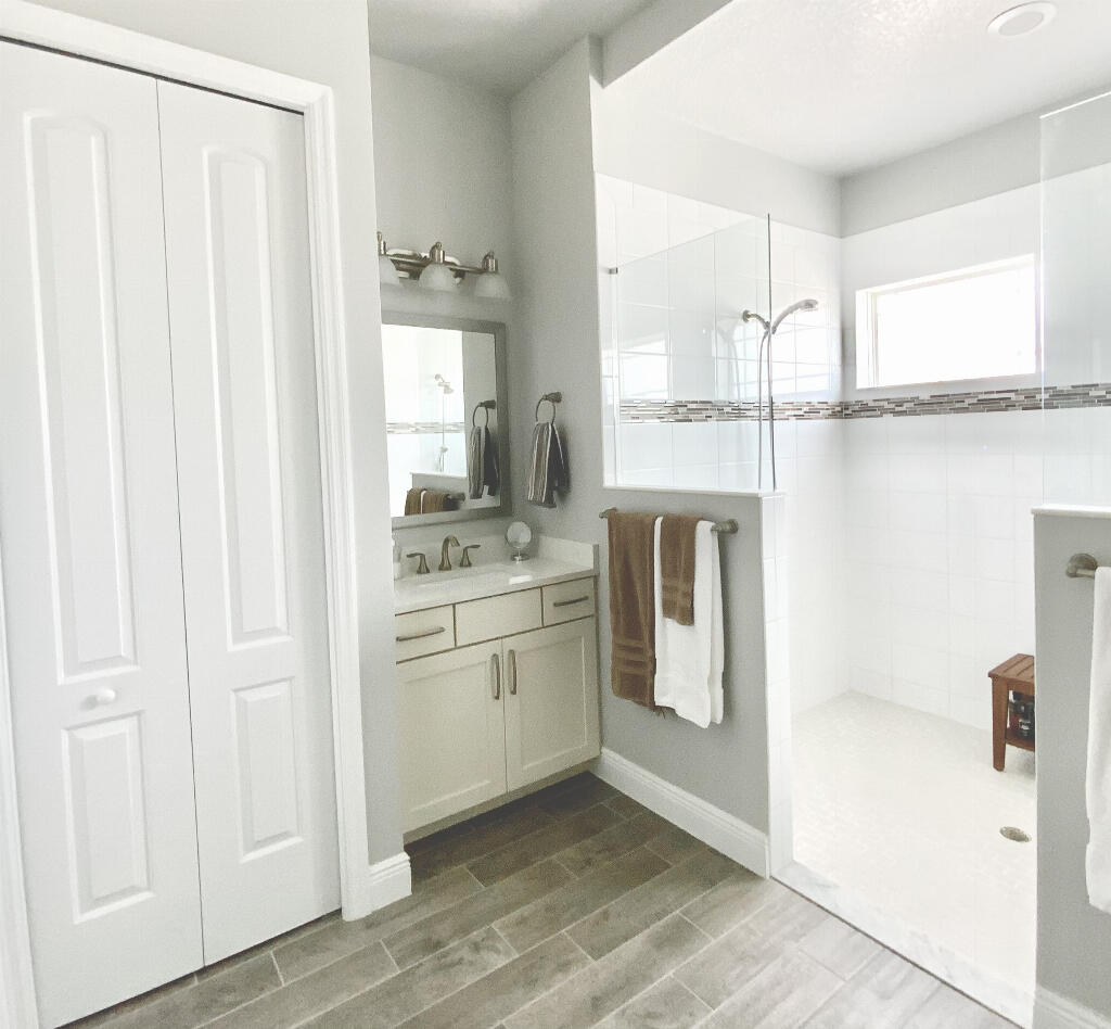4644 Capri Lane Melbourne, FL 32935 - Photo 24 of 43 a bathroom with a granite countertop sink and a mirror