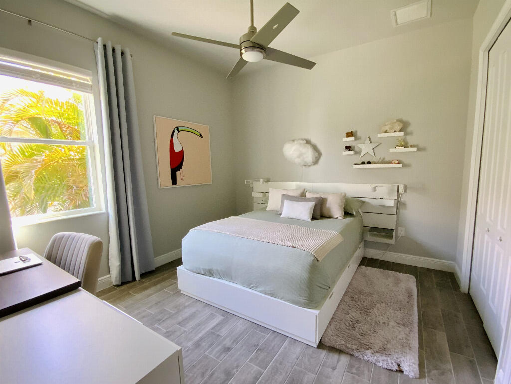 4644 Capri Lane Melbourne, FL 32935 - Photo 25 of 43 a bedroom with a bed and a couch