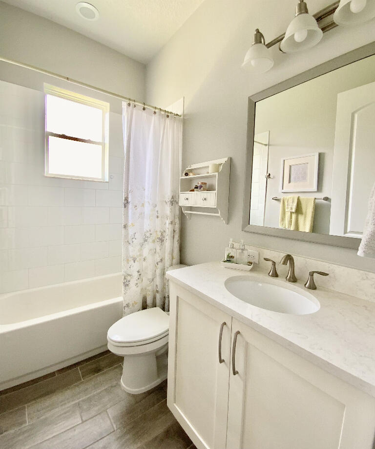 4644 Capri Lane Melbourne, FL 32935 - Photo 27 of 43 a bathroom with a sink a toilet and a bathtub