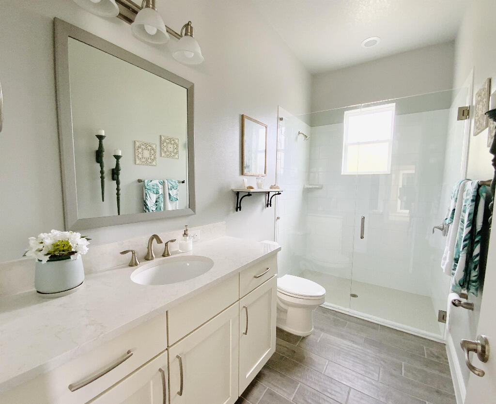 4644 Capri Lane Melbourne, FL 32935 - Photo 32 of 43 a bathroom with a sink toilet and shower