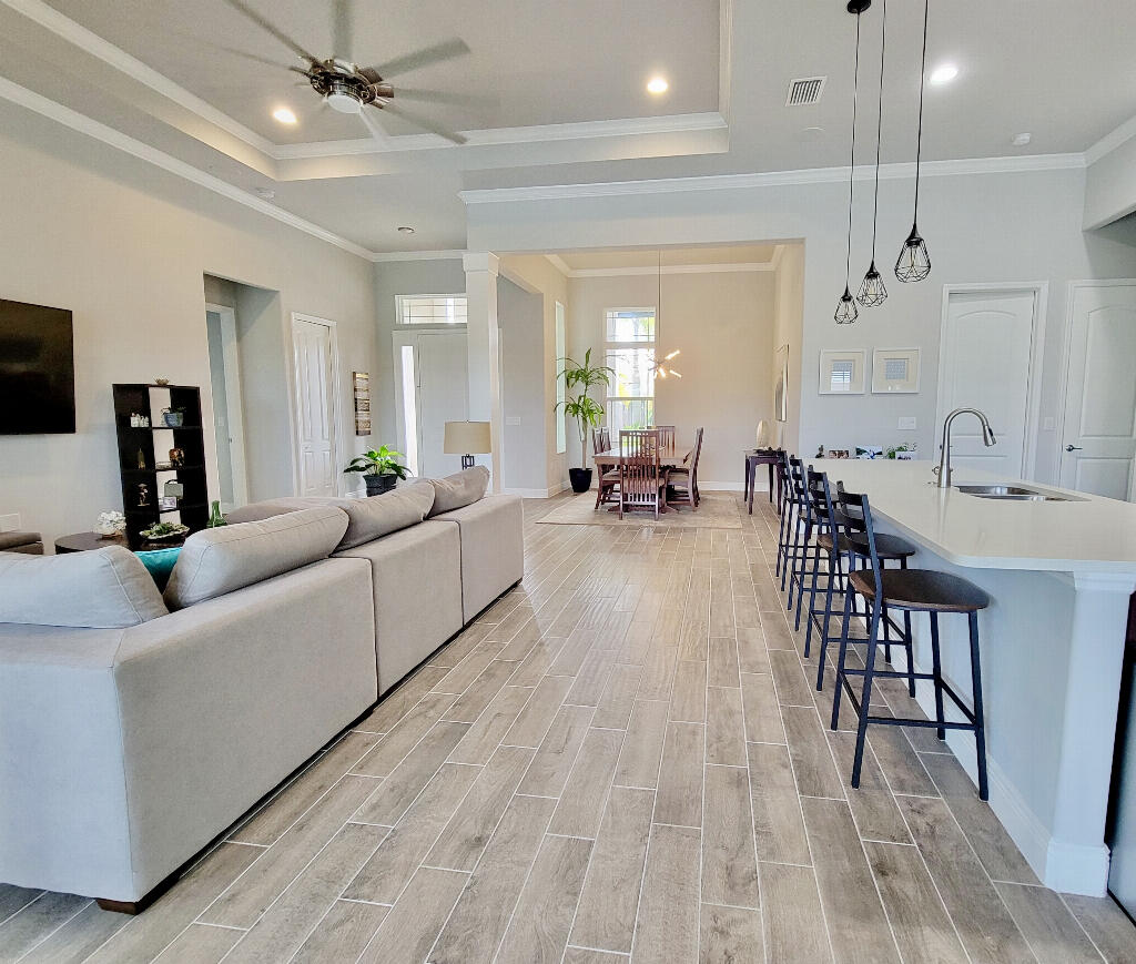 4644 Capri Lane Melbourne, FL 32935 - Photo 9 of 43 a living room with furniture and a wooden floor