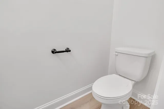 a white toilet sitting next to a shower