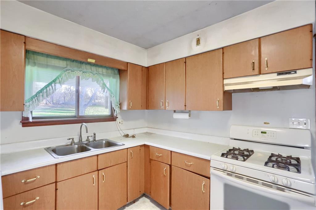 335 McCaslin Road New Castle, PA 16101 - Photo 12 of 31 a kitchen with stainless steel appliances granite countertop a sink stove and cabinets