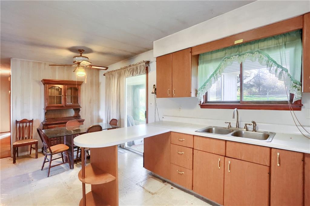 335 McCaslin Road New Castle, PA 16101 - Photo 13 of 31 a kitchen with stainless steel appliances wooden cabinets a table and chairs