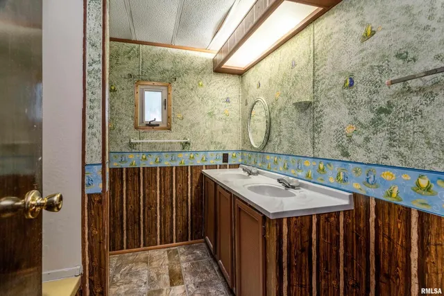 a bathroom with a sink and mirror