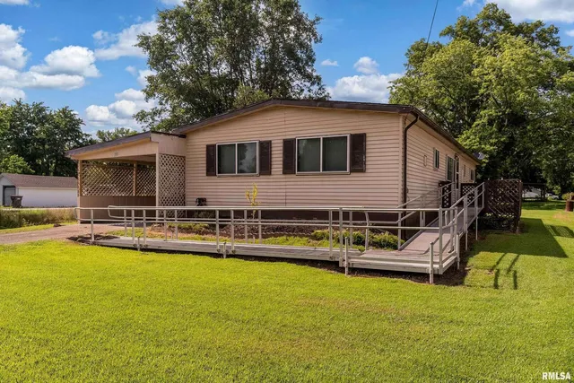 a front view of house with yard and swimming pool
