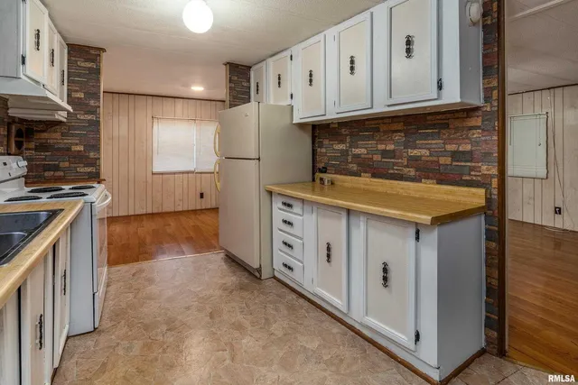 a kitchen with cabinets and a stove top oven