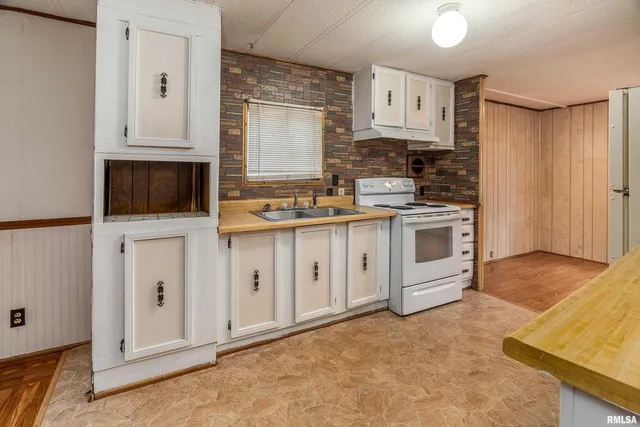 a kitchen with stainless steel appliances a stove top oven