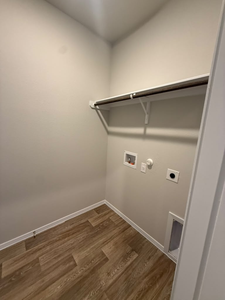 2601 Foss Road Manor, TX 78653 - Photo 8 of 40 Functional laundry closet features overhead storage and wood-look flooring.