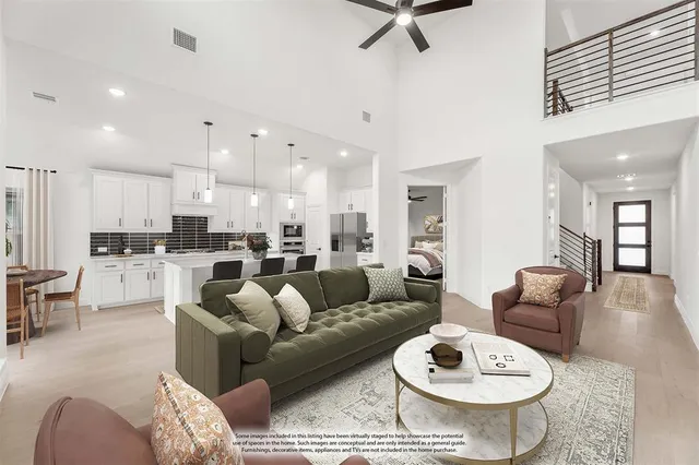 a living room with furniture kitchen view and a table