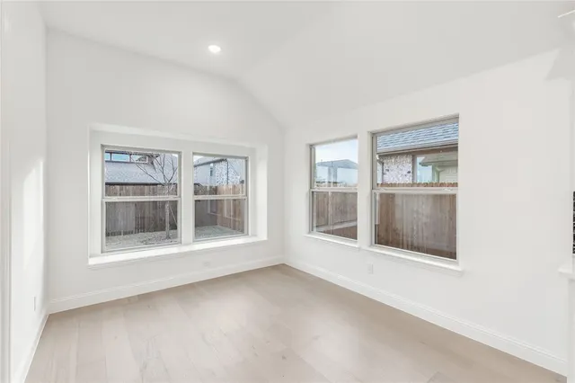an empty room with windows and entryway