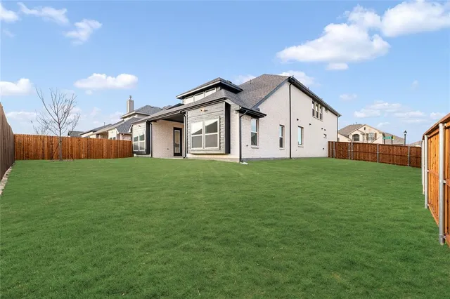 a view of a house with a big yard next to a yard