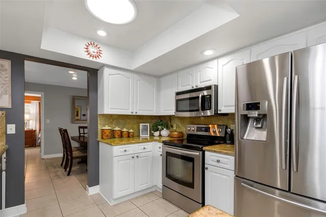 a dining room with furniture and a floor to ceiling window
