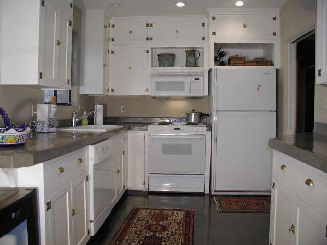 116 West Coronado Road Phoenix, AZ 85003 - Photo 3 of 6 a kitchen with white cabinets and white appliances