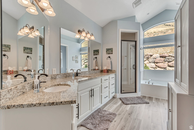 2543 East 700 South Springville, UT 84663 - Photo 46 of 73 Bathroom with double vanity, a chandelier, vaulted ceiling, a garden tub, and healthy amount of natural light