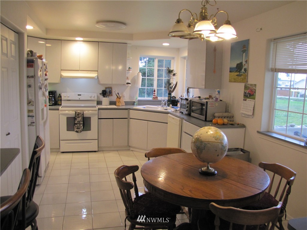 11 Stone Road Sequim, WA 98382 - Photo 15 of 21 a kitchen with stainless steel appliances granite countertop a sink a stove a dining table and chairs