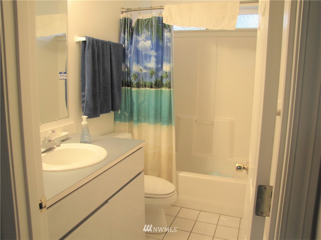 11 Stone Road Sequim, WA 98382 - Photo 18 of 21 a bathroom with a granite countertop sink toilet and shower