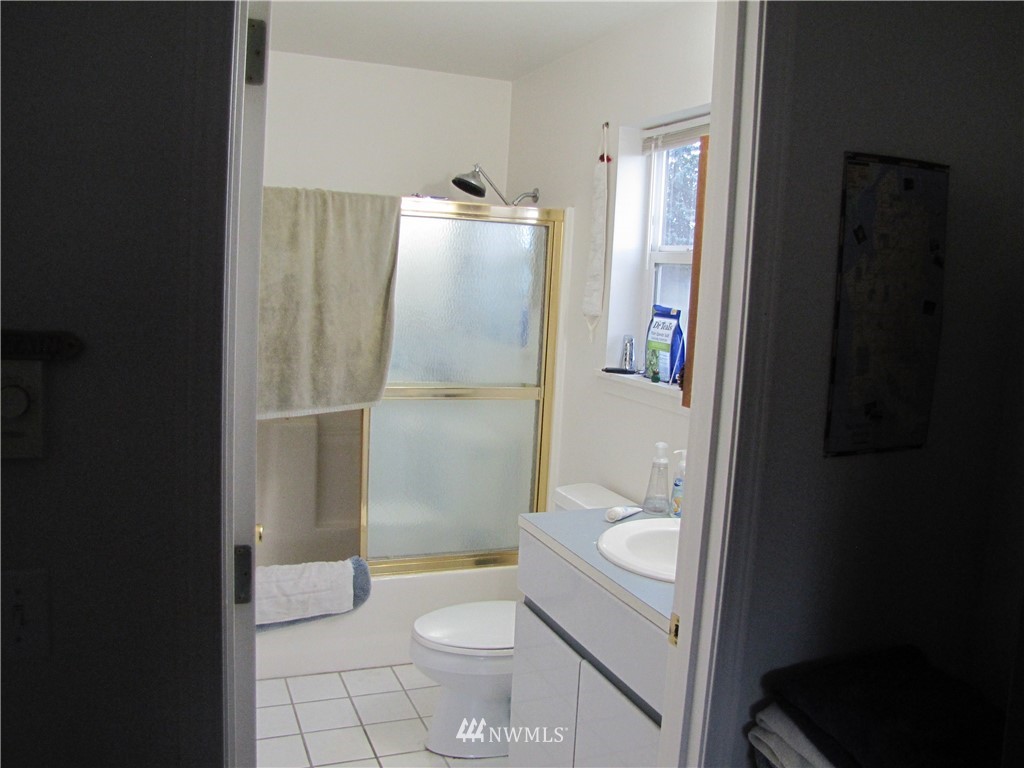 11 Stone Road Sequim, WA 98382 - Photo 20 of 21 a bathroom with a granite countertop toilet a sink and a mirror