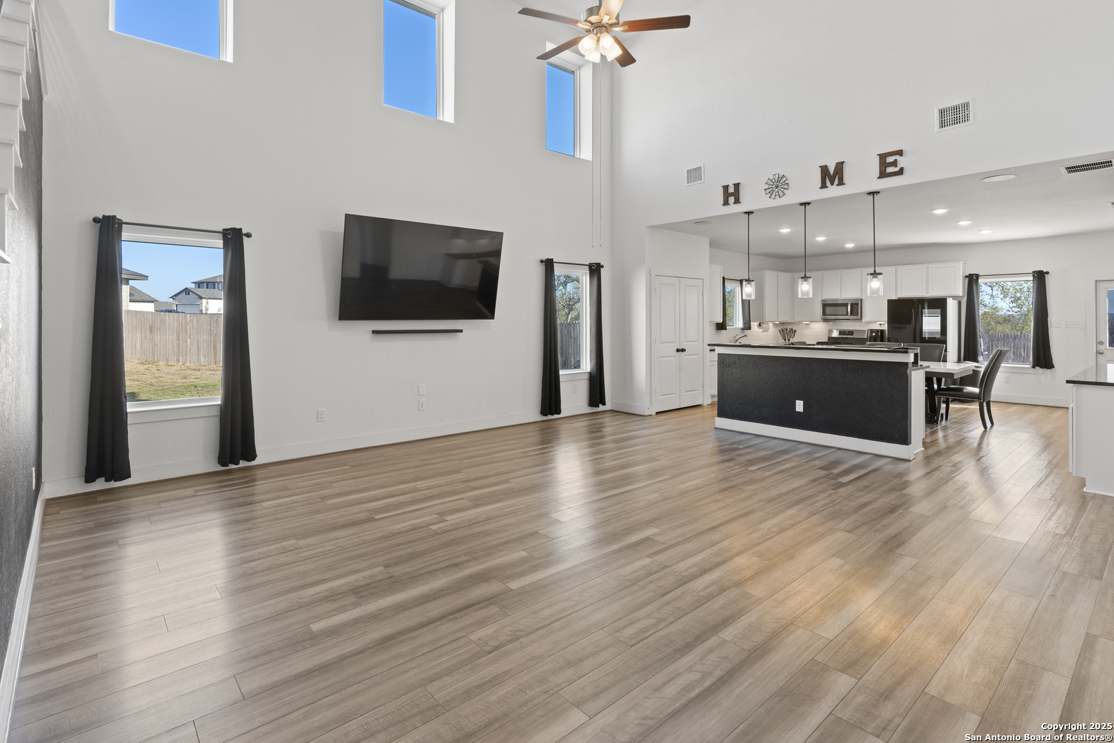 8823 Catnip Pass Elmendorf, TX 78112 - Photo 16 of 34 a view of a living room and kitchen with wooden floor