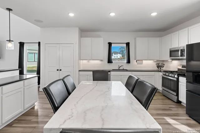 a kitchen with a sink appliances and cabinets