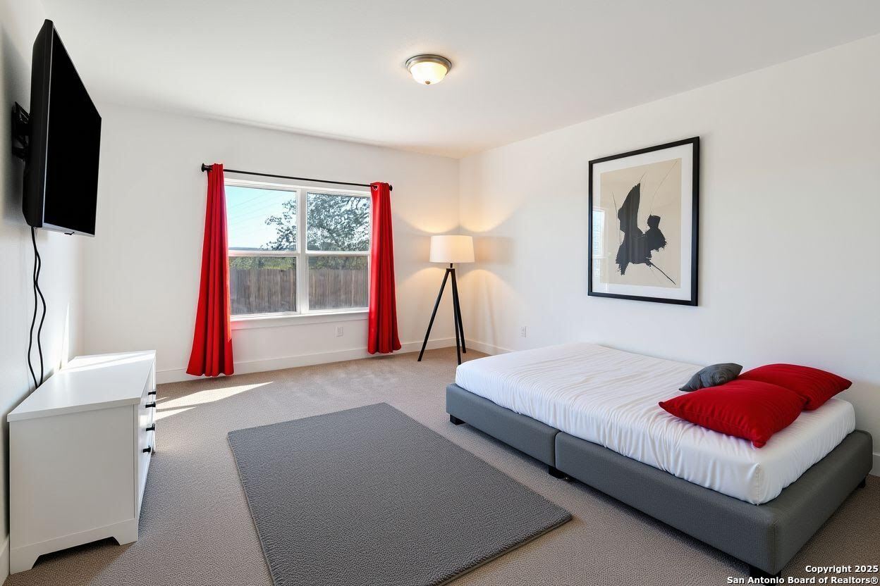 8823 Catnip Pass Elmendorf, TX 78112 - Photo 21 of 34 a living room with furniture and a flat screen tv