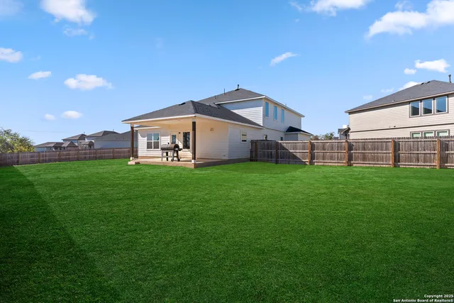 a view of a house with a backyard