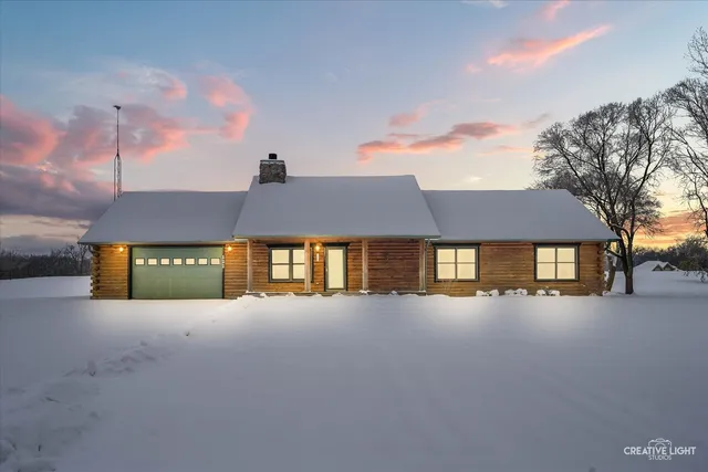 a front view of a house with yard and garage