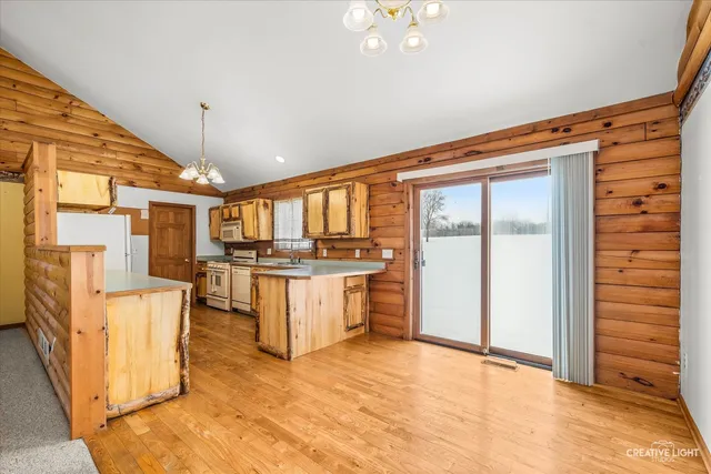 a kitchen with stainless steel appliances granite countertop a sink a stove and a refrigerator