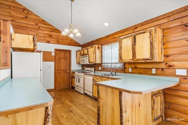 a kitchen with stainless steel appliances granite countertop a sink and cabinets
