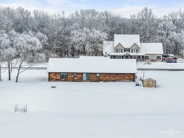 a view of backyard with large trees and wooden fence