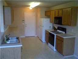 The kitchen features lots of counter and cabinet space, as well as a great view from the bay window. 