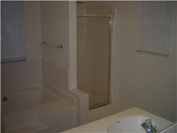Master bathroom offers separate shower and garden tub, as well as his/her sinks.