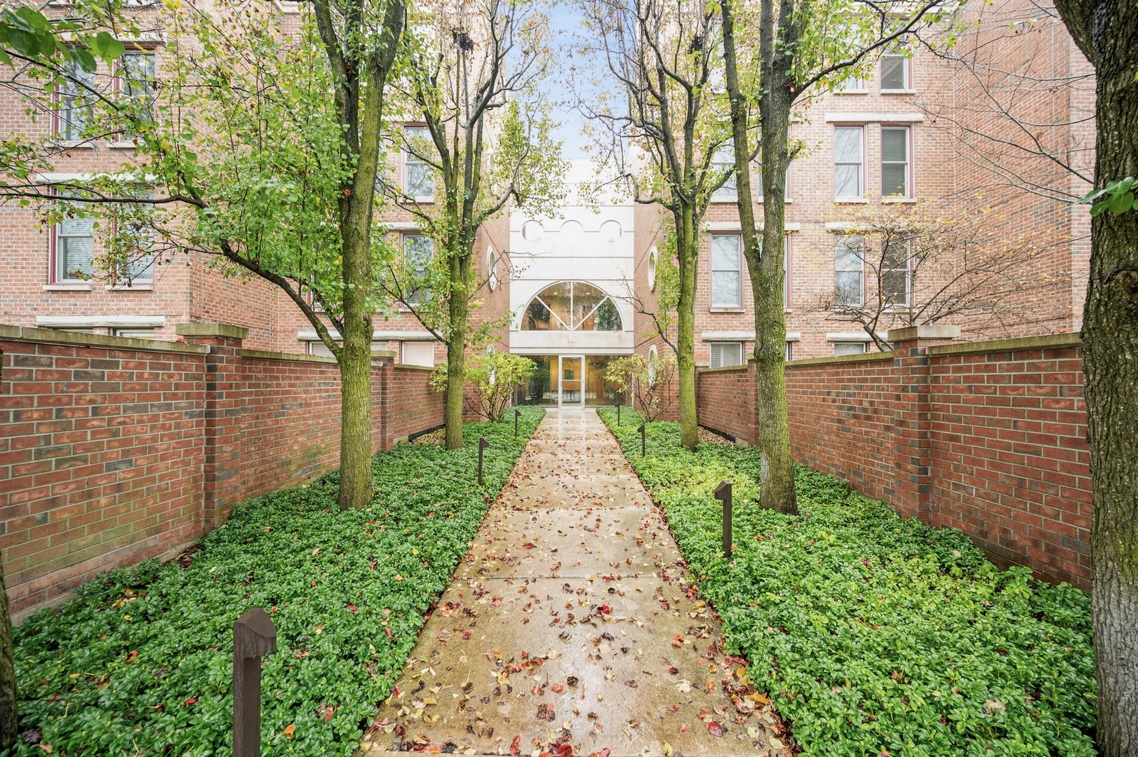 360 Green Bay Road, Unit 4C Winnetka, IL 60093 - Photo 1 of 16 a view of a pathway both side of house with a garden