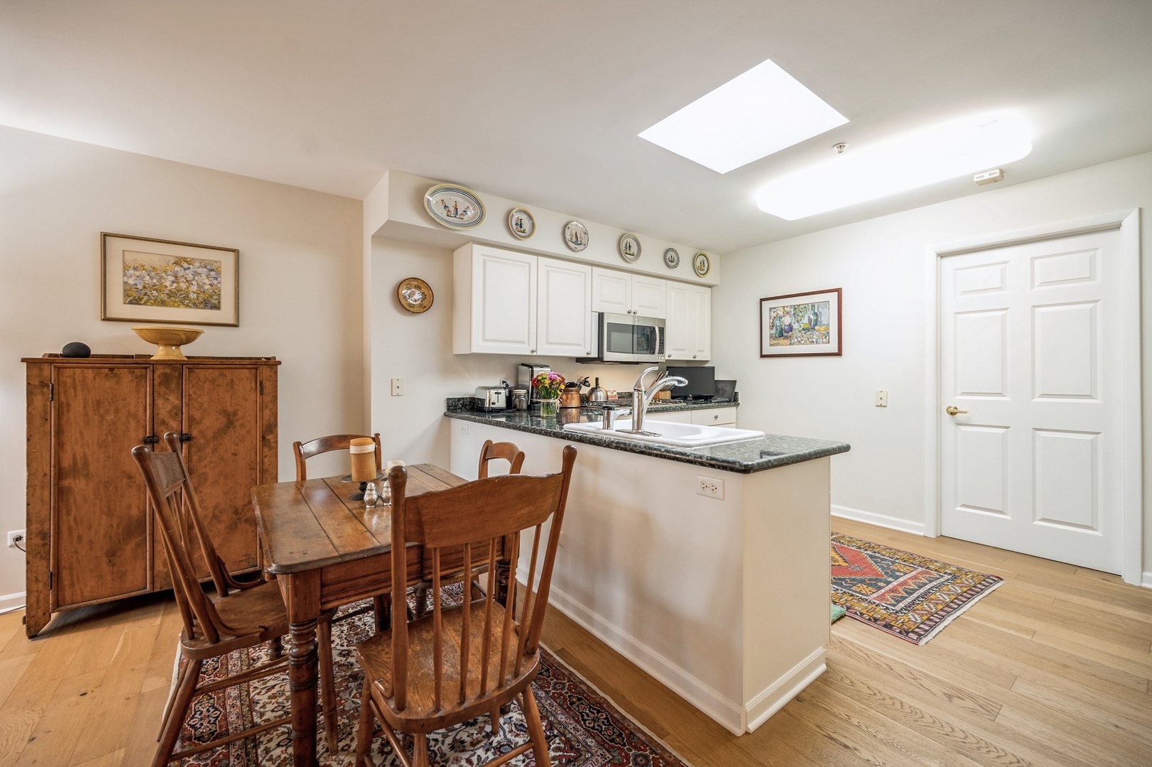 360 Green Bay Road, Unit 4C Winnetka, IL 60093 - Photo 11 of 16 a kitchen with stainless steel appliances granite countertop a table and chairs