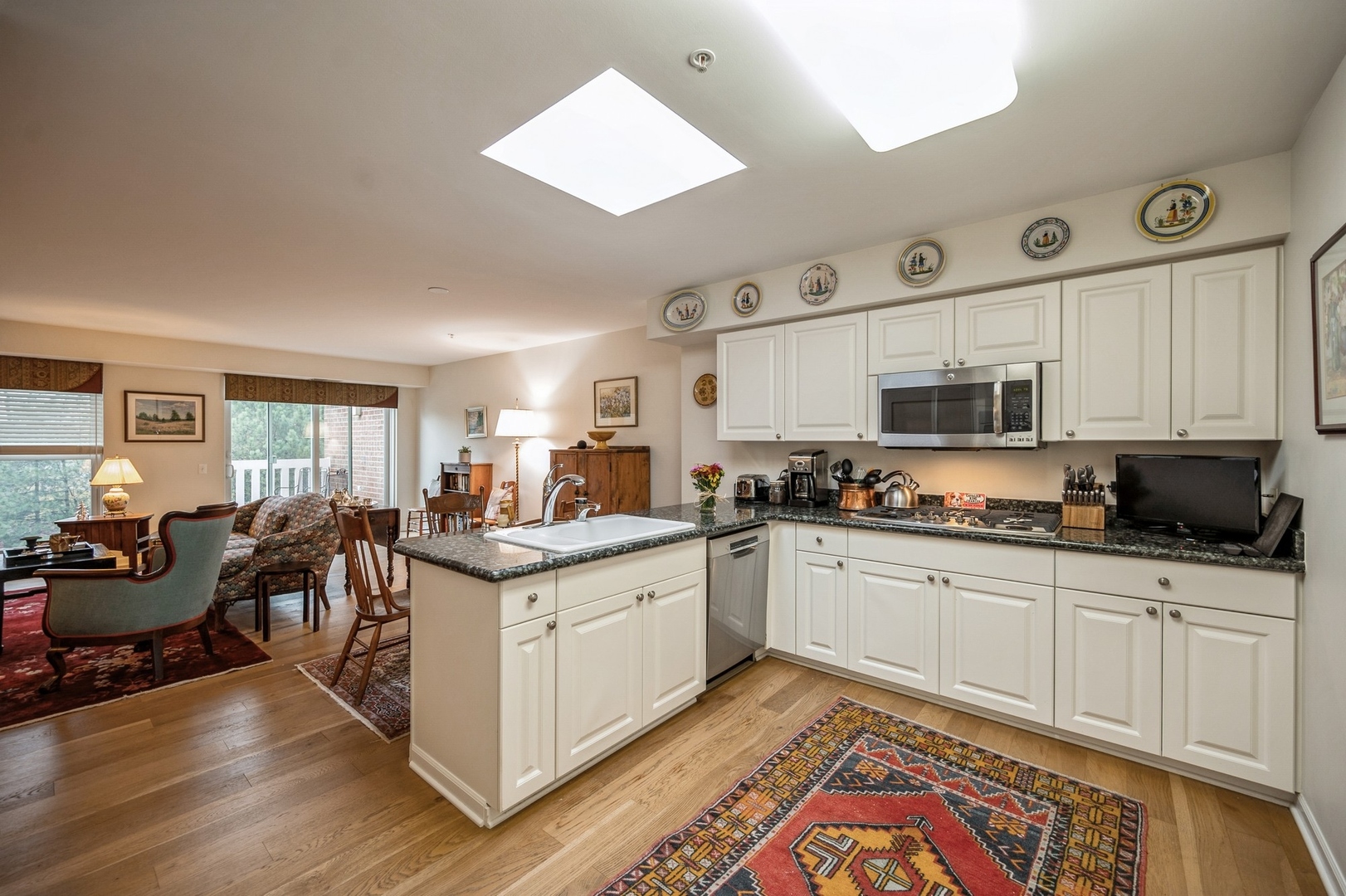 360 Green Bay Road, Unit 4C Winnetka, IL 60093 - Photo 9 of 16 a kitchen with stainless steel appliances granite countertop a stove and cabinets