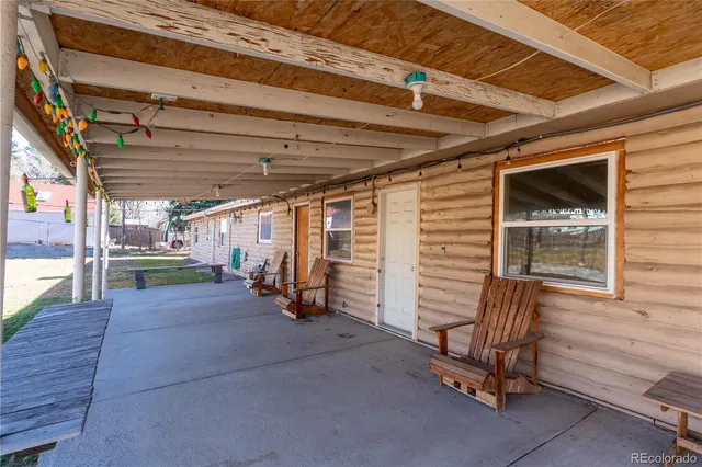 a view of a porch with furniture and a gate