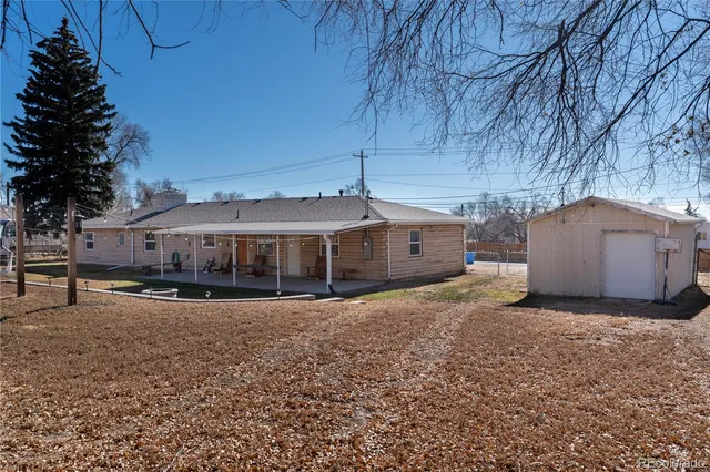 a view of a house with a yard and sitting area