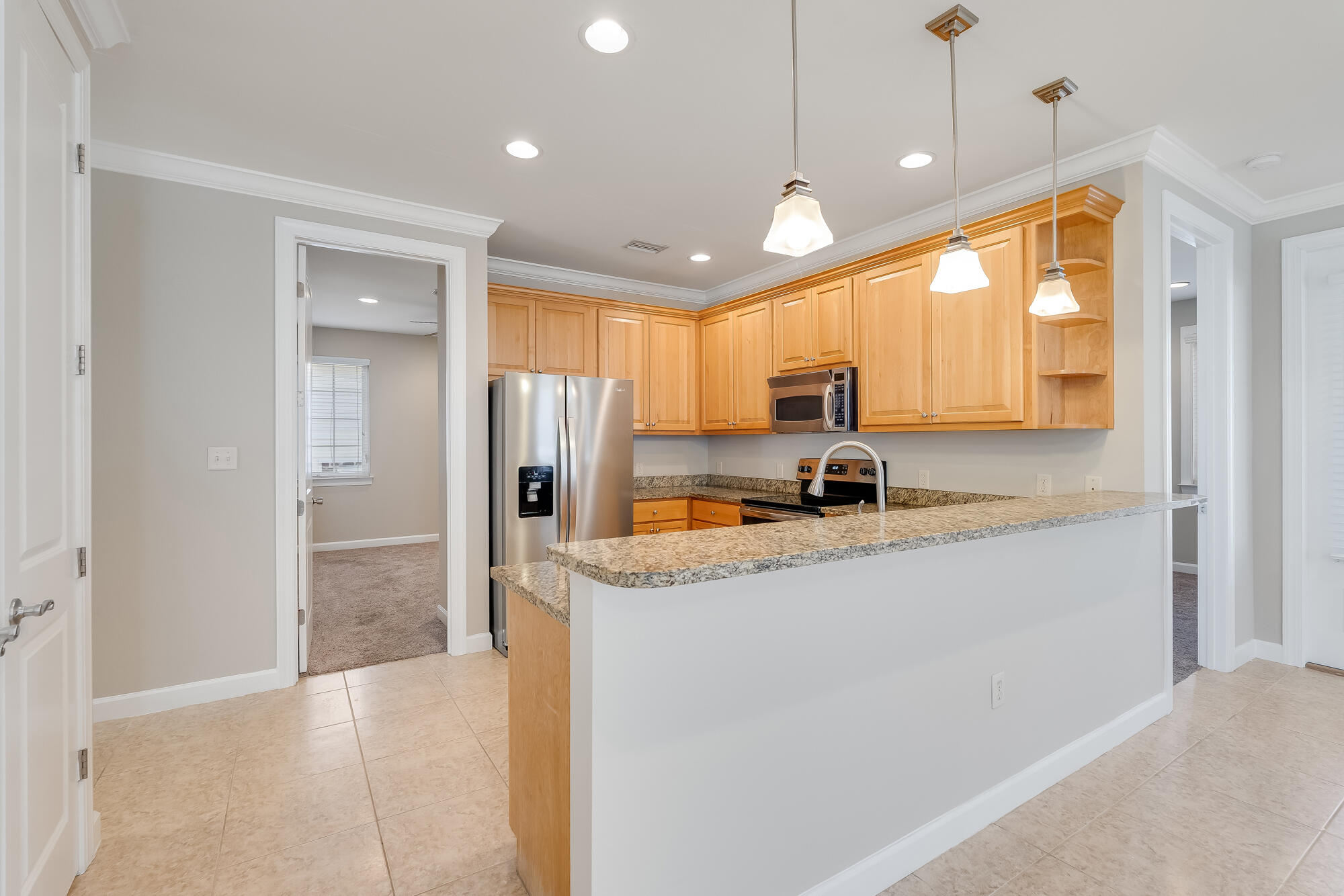 174 South Zander Way Santa Rosa Beach, FL 32459 - Photo 7 of 20 a kitchen with granite countertop a refrigerator and a sink