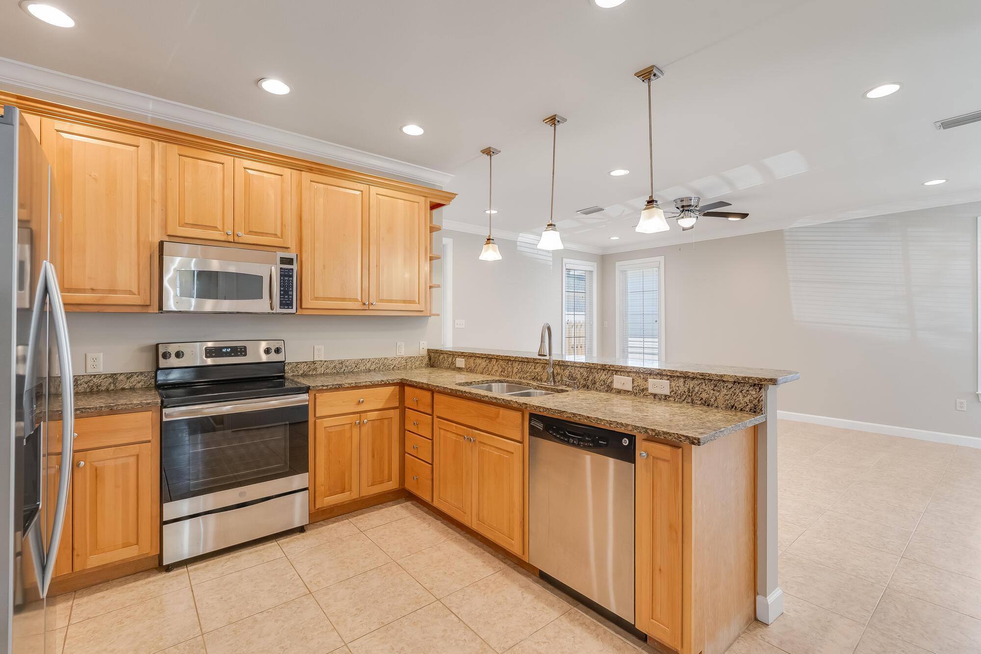 174 South Zander Way Santa Rosa Beach, FL 32459 - Photo 8 of 20 a kitchen with stainless steel appliances granite countertop a stove a sink and a microwave