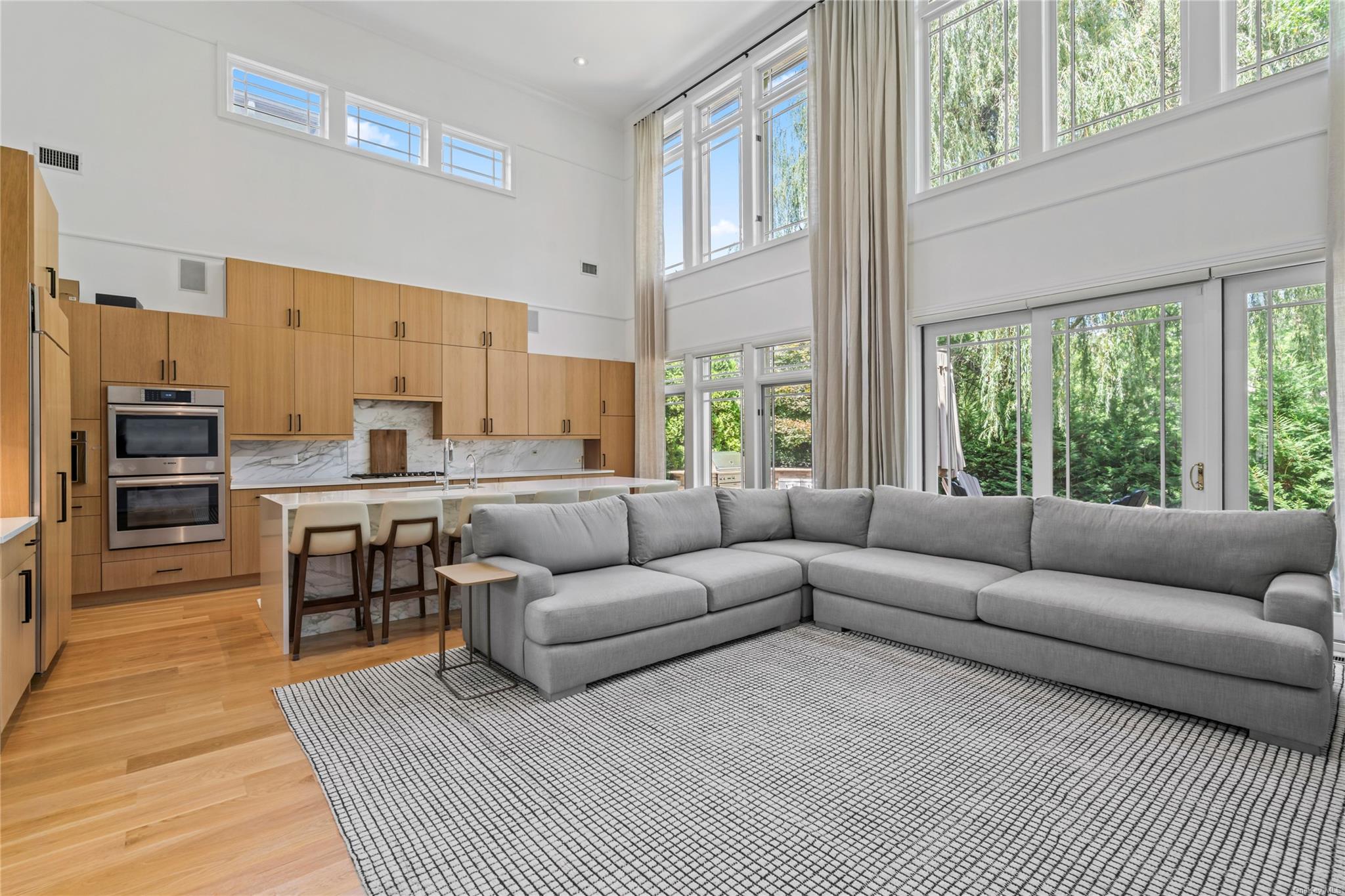 8 Holiday Pond Road Jericho, NY 11753 - Photo 11 of 43 Living area featuring a high ceiling and light wood finished floors