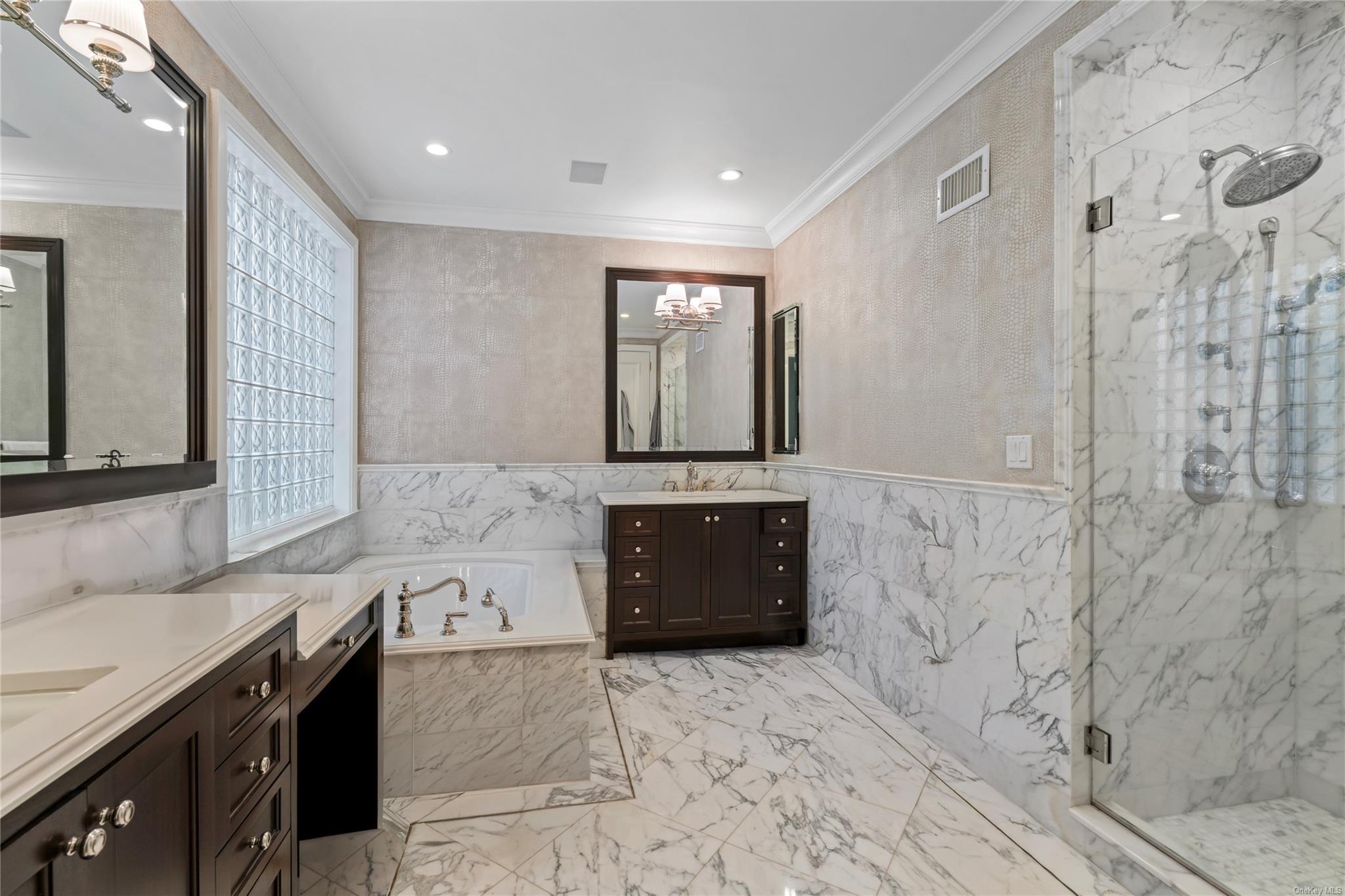 8 Holiday Pond Road Jericho, NY 11753 - Photo 23 of 43 Bathroom featuring two vanities, a marble finish shower, a garden tub, crown molding, and tile walls