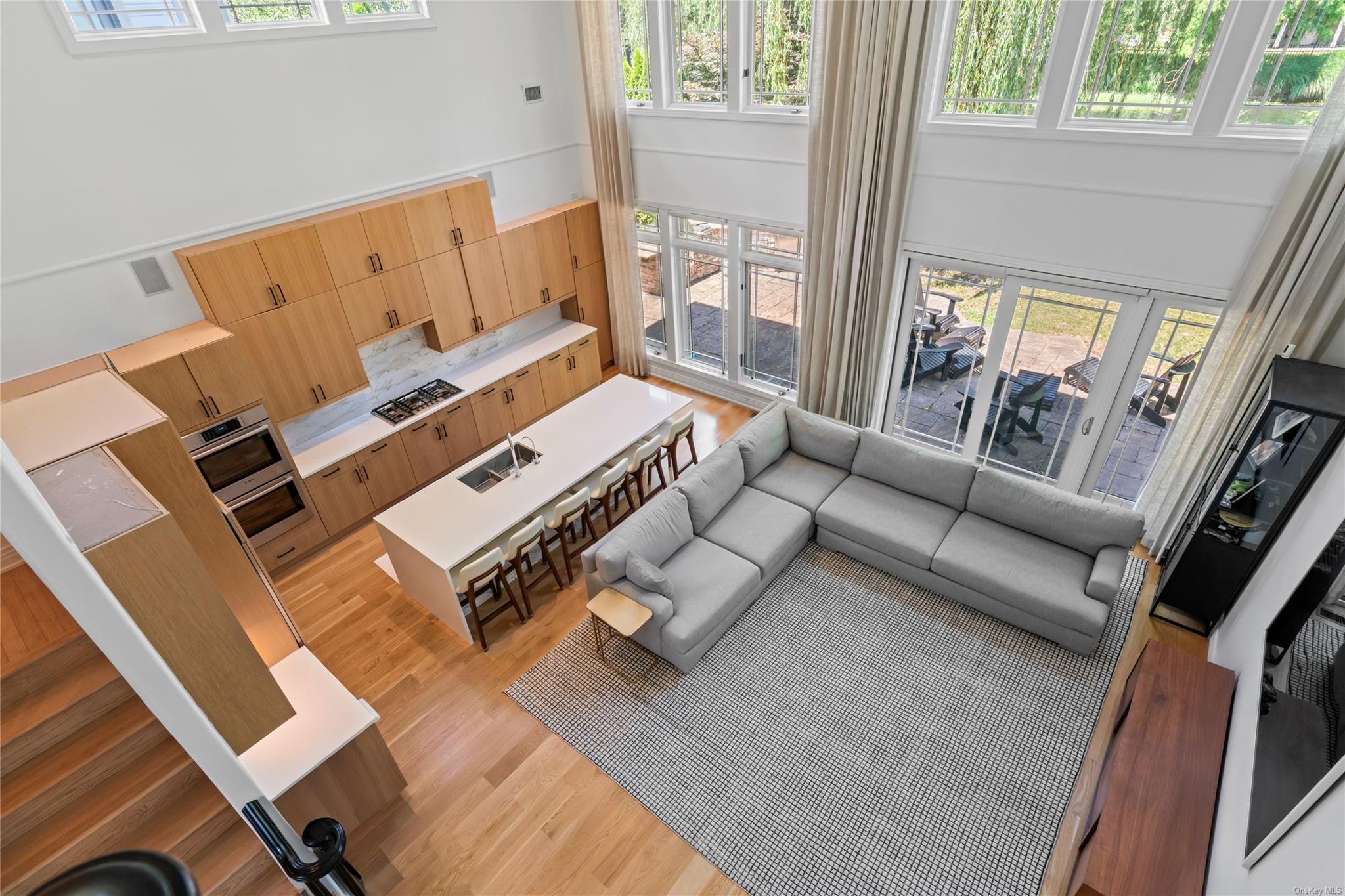 8 Holiday Pond Road Jericho, NY 11753 - Photo 29 of 43 Living room featuring light wood-style flooring and a high ceiling